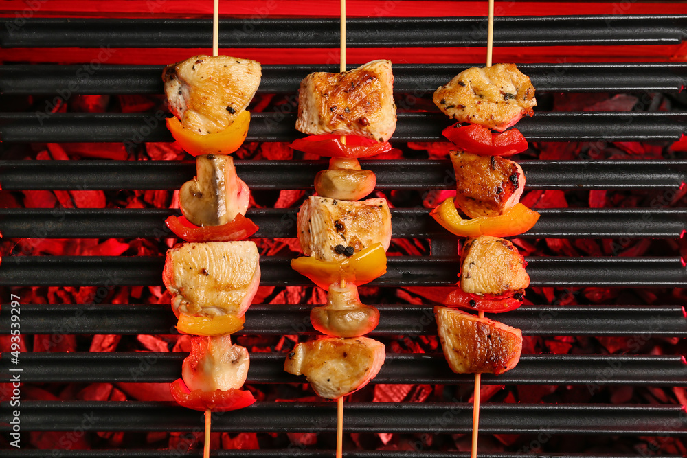 Tasty chicken skewers with vegetables on grill