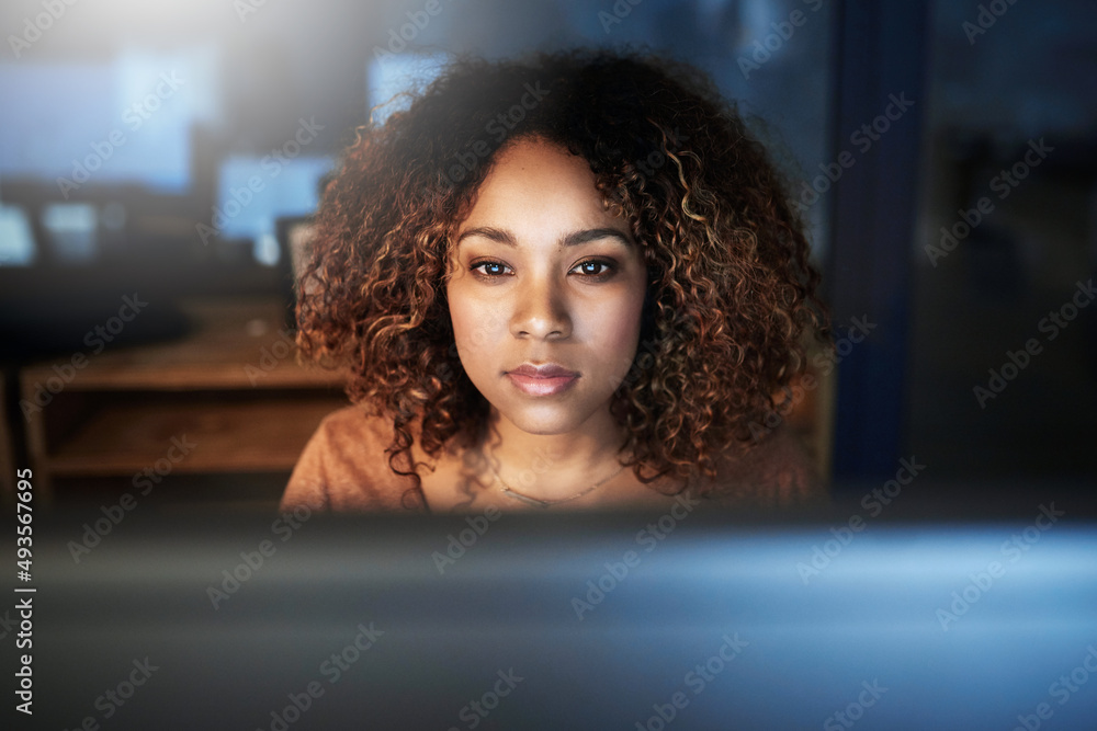 Getting it right, no matter the hour. Shot of a young woman working late in an empty office.