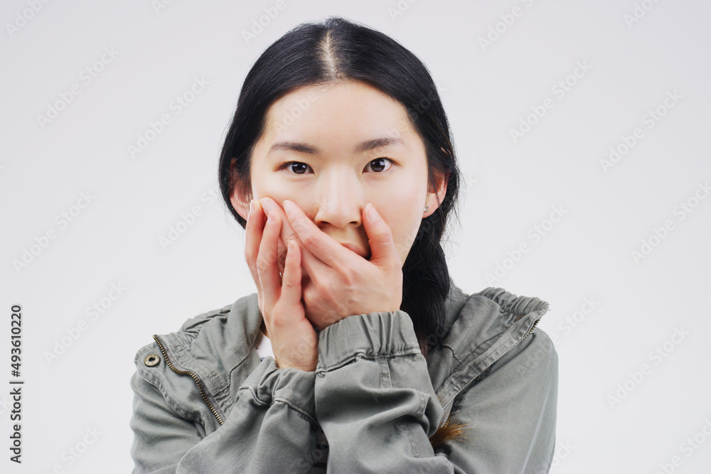 Woah How did you do that. Studio shot of a young woman looking shocked against a grey background.