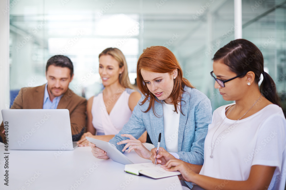 Taking teamwork to the next level. Shot of a team of coworkers strategising.