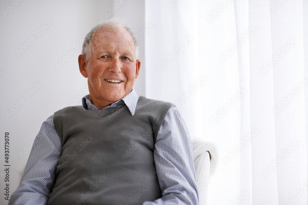 Positive attitudes are the way to go. Portrait of a smiling senior man relaxing in a chair.