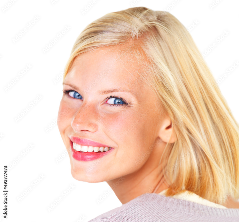 Giving you a beautiful grin. Gorgeous young blond woman smiling happily against a white background.