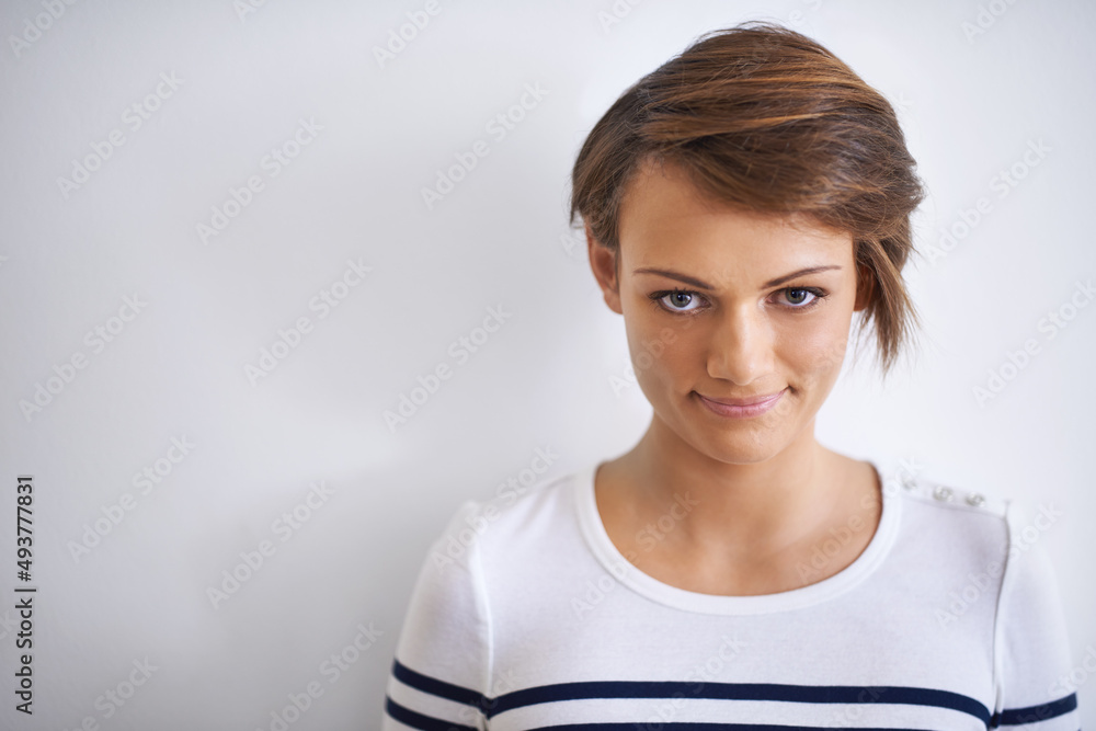 Shell look you right in the eye. A cropped portrait of a beautiful young girl standing against a whi