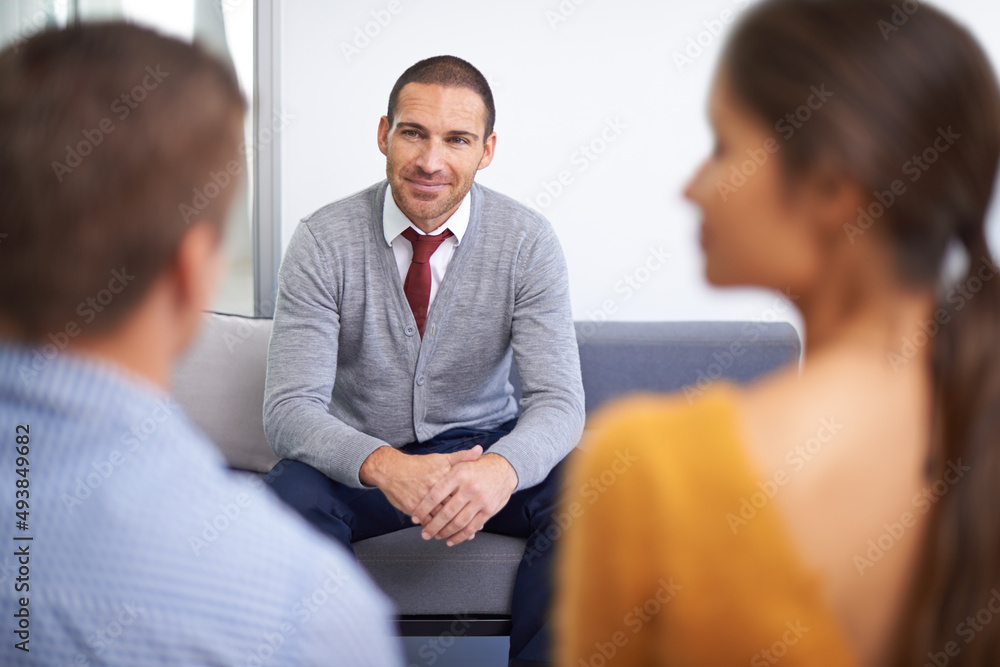 An exciting job interview. An attractive businessman being interviewed by two businesspeople.