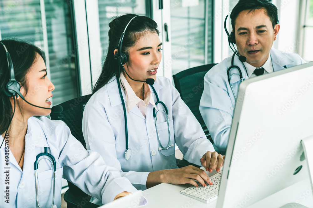 Doctor team wearing headset talking actively on video call in hospital clinic . Concept of telehealt