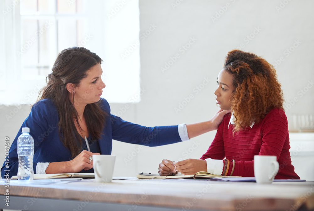 Tell me about it. Shot of two colleagues having a discussion in an office.