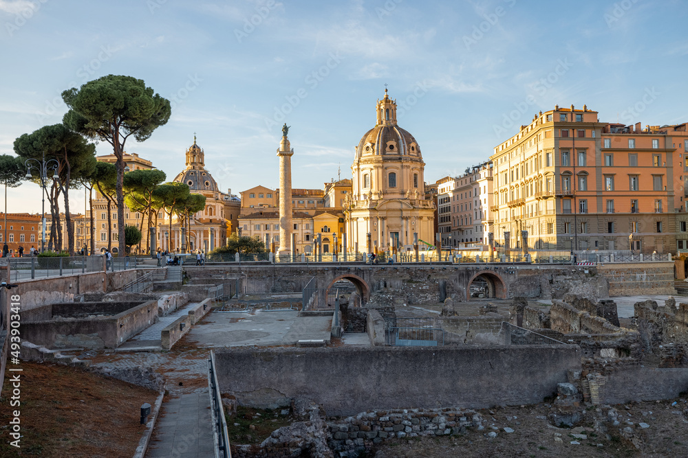 Scenic view on ruins of Roman Forum with Churches on skyline. Rome cityscape on sunset. Concept of h