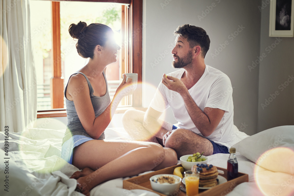 You have no idea how happy I am right now. Shot of a happy young couple enjoying breakfast in bed to