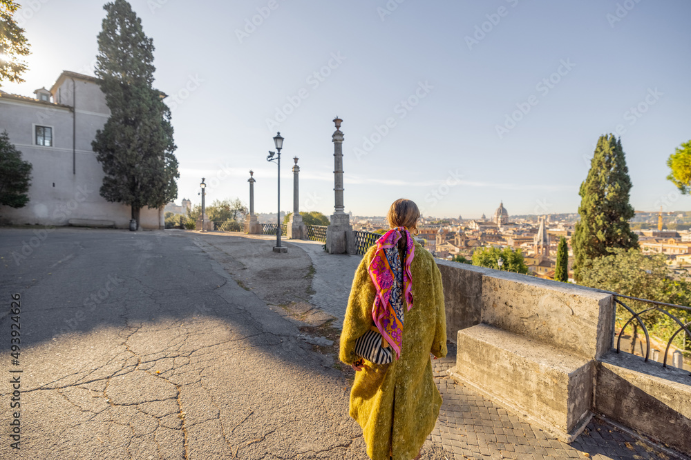 Woman enjoying beautiful morning cityscape of Rome, walking in Villa Borghese Park. Old fashioned wo