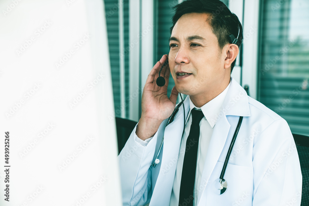 Doctor wearing headset talking actively on video call in a clinic or hospital . Concept of telehealt