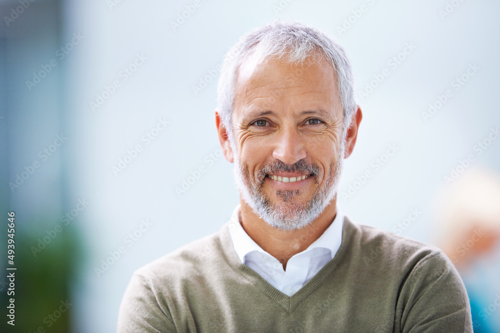 Its all about the positivity. Portrait of a mature businessman standing in an office.