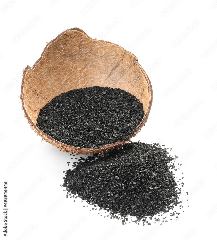 Coconut shell with activated carbon on white background