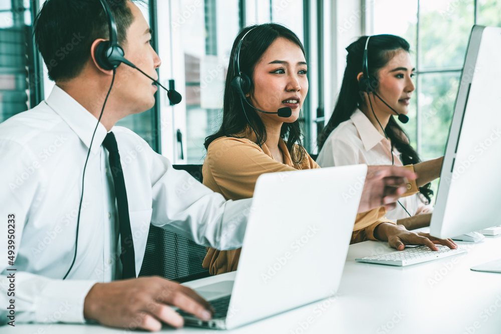 Business people wearing headset working actively in office . Call center, telemarketing, customer su