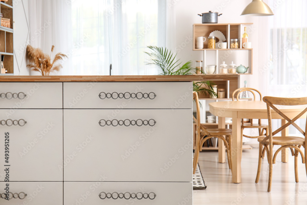 Modern table with drawers in light kitchen