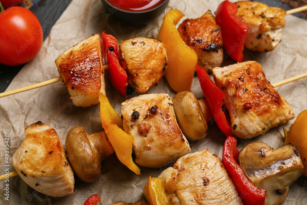 Grilled chicken skewers with vegetables on table, closeup