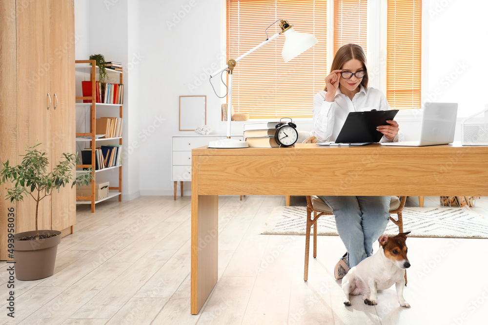 Beautiful businesswoman working with document at table in office