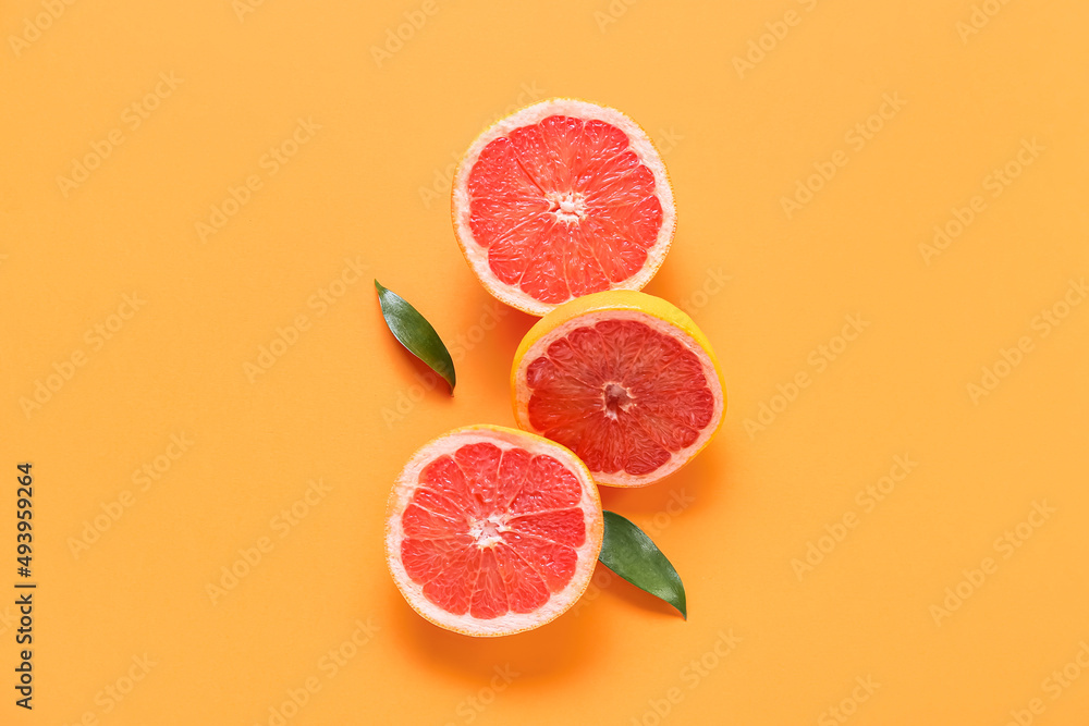 Fresh grapefruit pieces on orange background