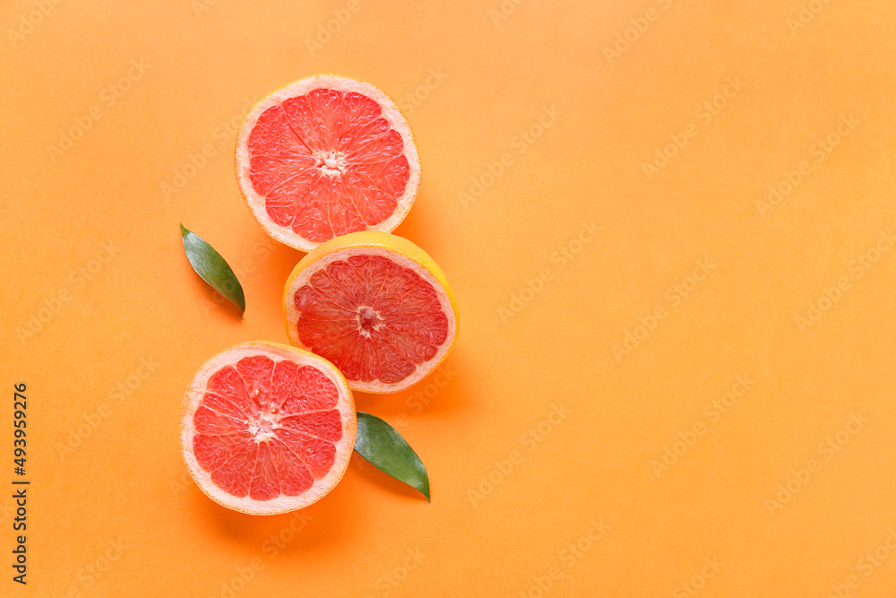 Fresh grapefruit pieces on orange background