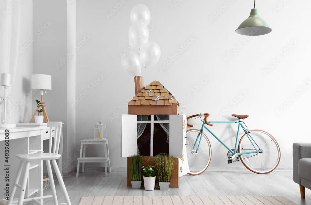 Cardboard toy house for child in room