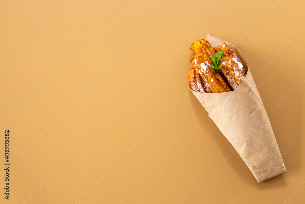 Fast food sweets - churros in paper bag