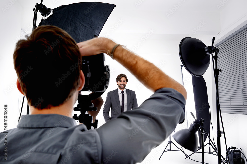 The photographers craft. Shot of a photographer working in his studio.