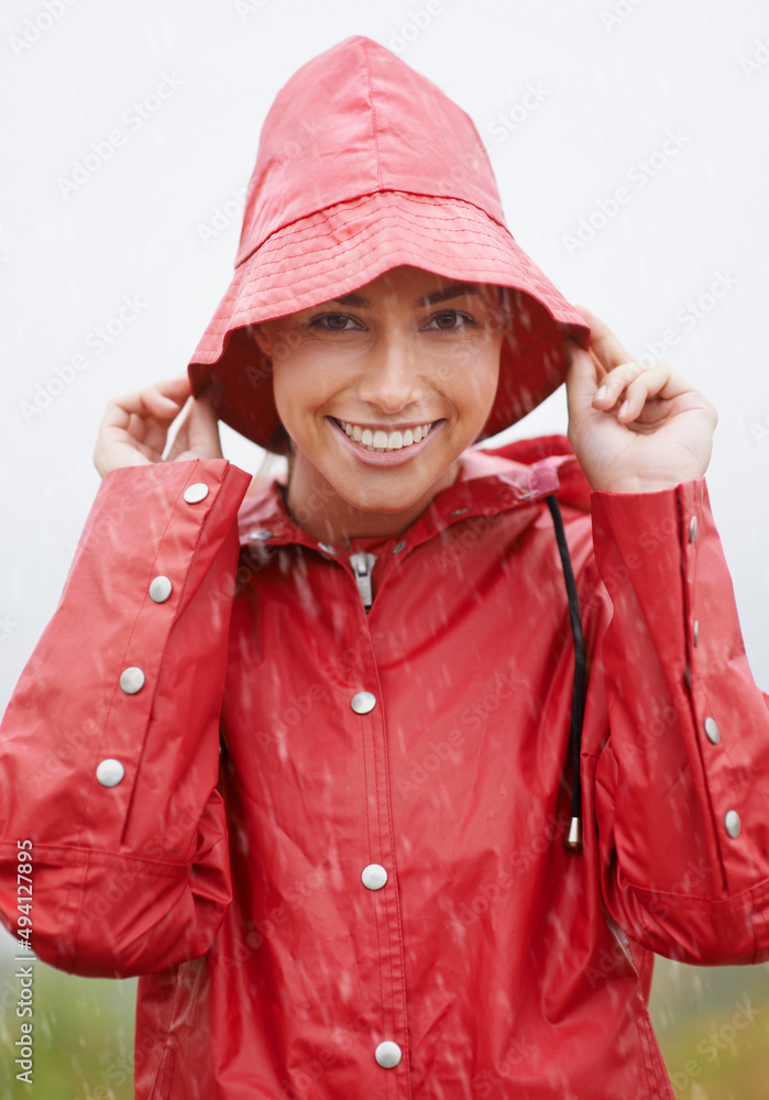 Im ready for any weather. Cropped shot of an attractive young woman standing in the rain.