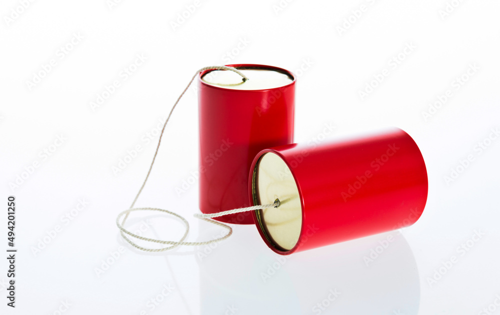 Red tin cans telephone isolated on white background