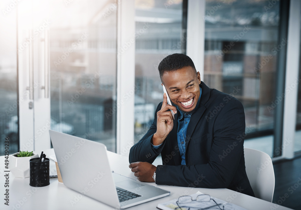 Thank you for letting me know the good news. Shot of a handsome young businessman talking on a cellp