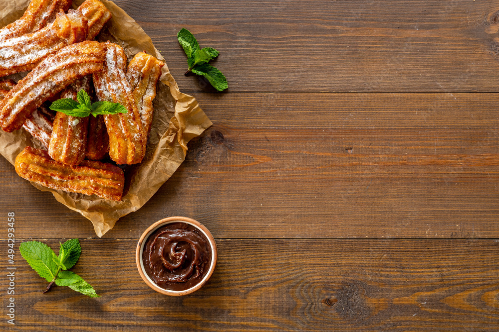 Treat churros with sugar served on baking paper