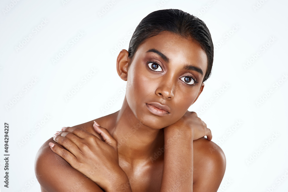 Skin care is the first step of self care. Studio shot of a beautiful young woman posing against a li