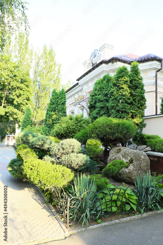 View of beautiful landscape design and small metal fence