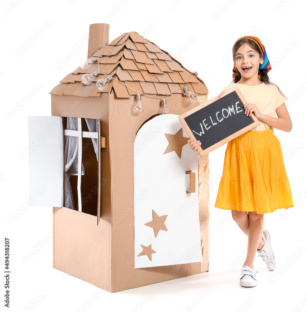 Funny little girl playing with cardboard house on white background