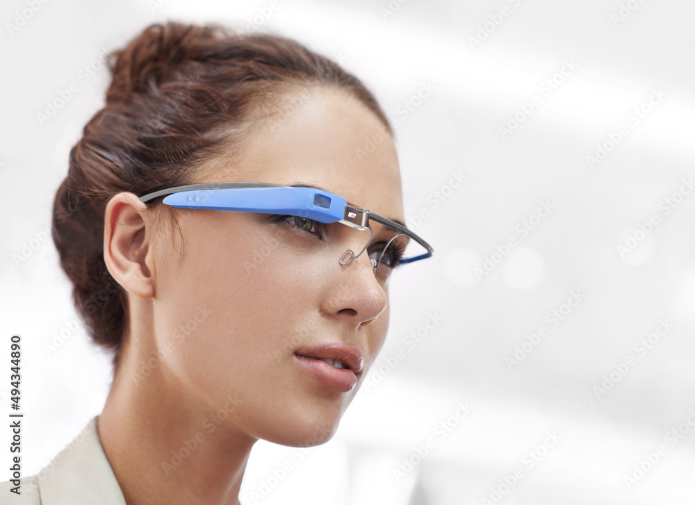 Cropped shot of an attractive young woman wearing glasses with internet access. The commercial produ