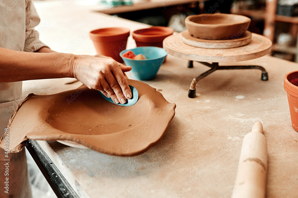 I have to smooth it out first. Cropped shot of an unrecognizable artisan working in a pottery worksh