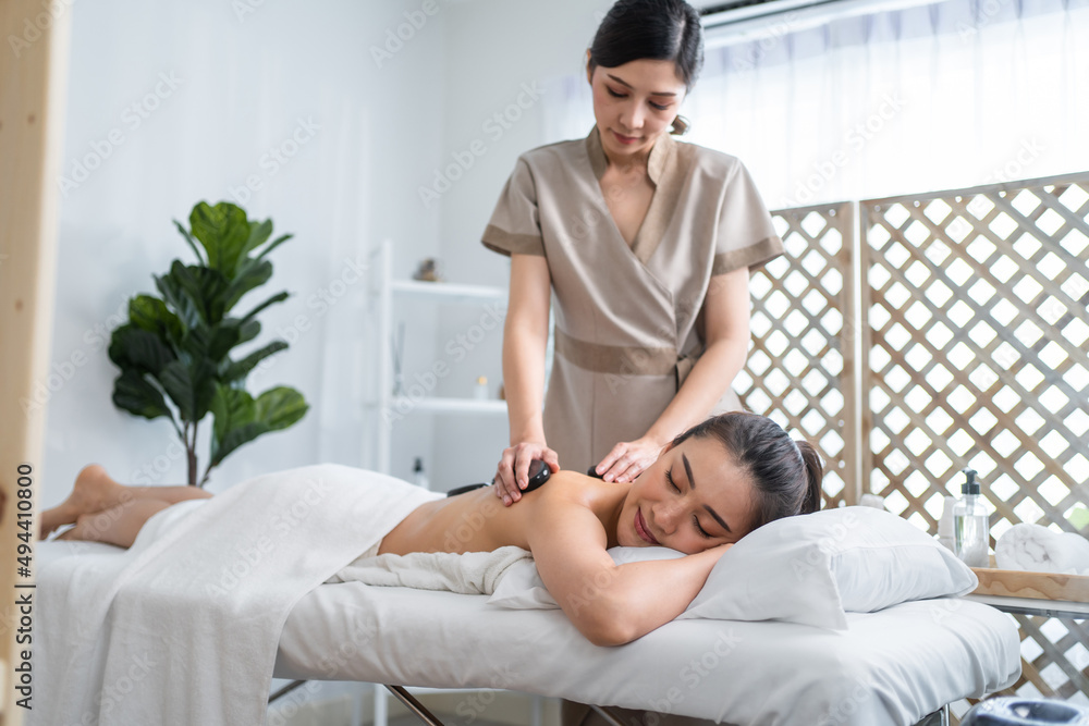 Asian young woman feeling happy and relax during back massage with oil