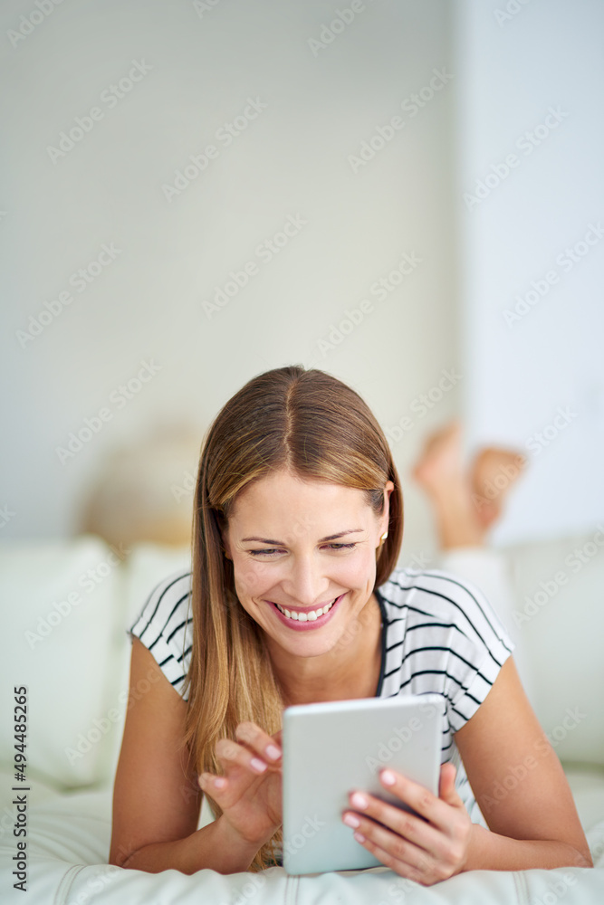 Enjoying some memes. Shot of a young woman browsing the internet at home.