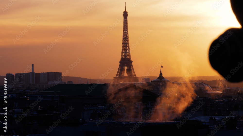 Scenic view of the Eiffel tower at orange sunset