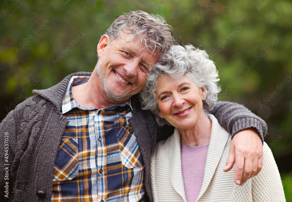 They share a lifetime of memories. Portrait of a loving senior couple standing together outdoors.