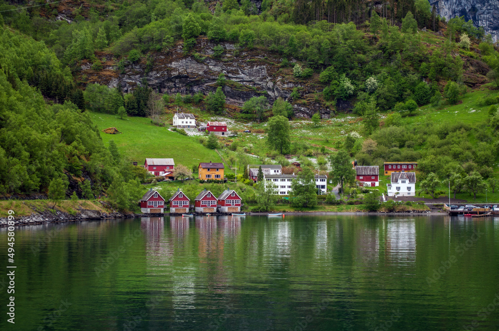 A small village with colorful wooden houses on the shores of a fjord in Norway.