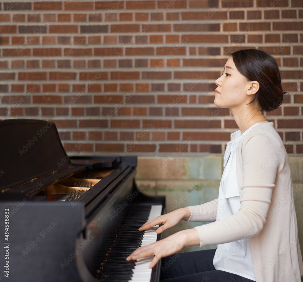 Playing from the heart. Cropped shot of pianist playing the piano.