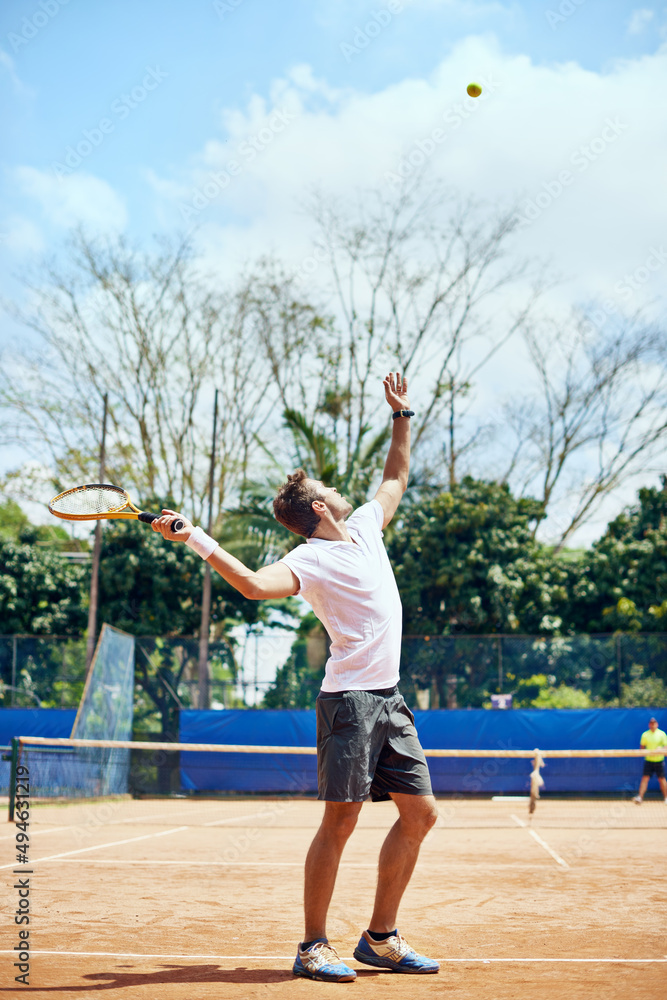 The serve. Shot of a tennis player serving.