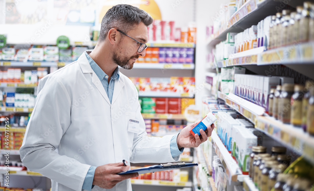 Stocking the shelves is top priority. Shot of a mature pharmacist doing inventory in a pharmacy.