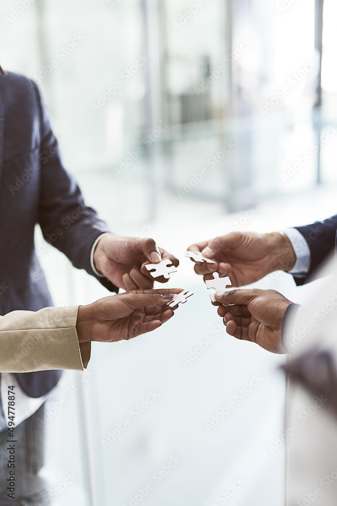 Building on their collective vision. Closeup shot of a group of unrecognizable businesspeople joinin