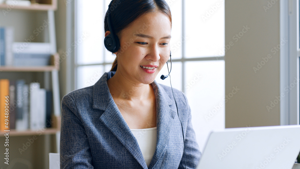 Young Asian businesswoman wearing headphone, call center, customer service talking on video call con