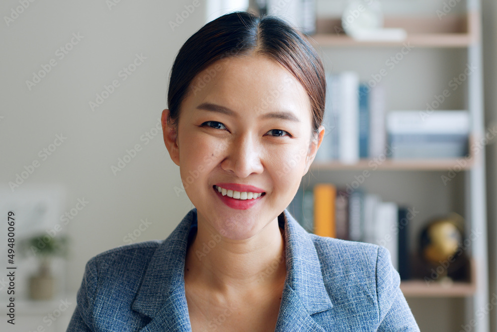 Portrait of young Asian businesswoman working in formal suit look at camera and smile