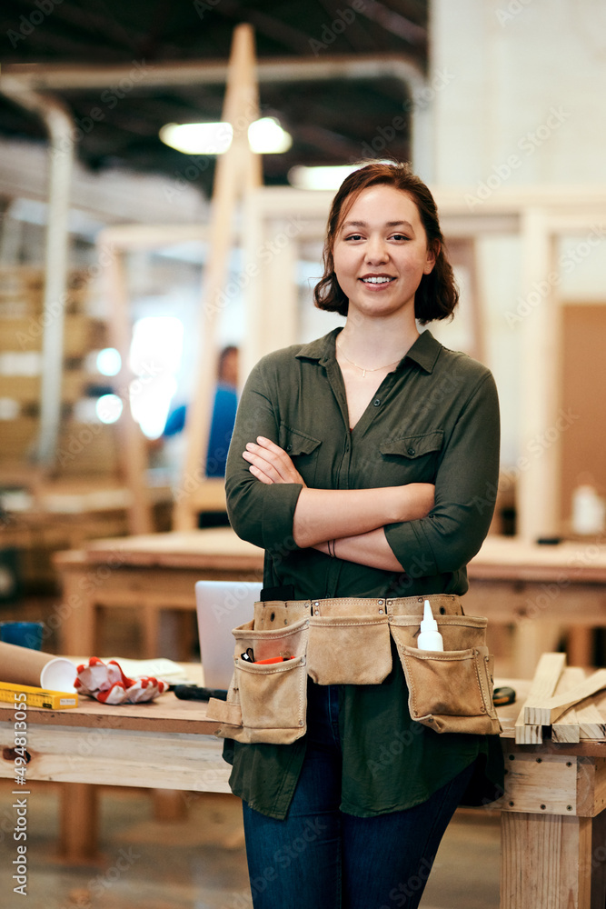 Making things is my favorite thing to do. Cropped shot of a young female carpenter smiling at the ca