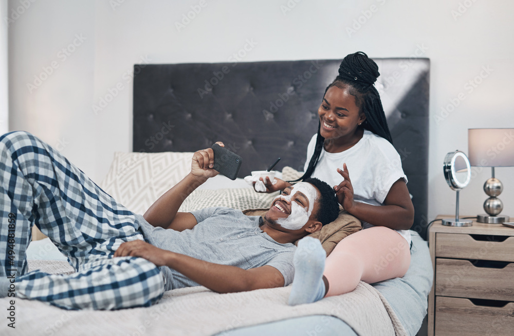 My love gave me this glow. Shot of a young couple taking selfies while getting homemade facials toge