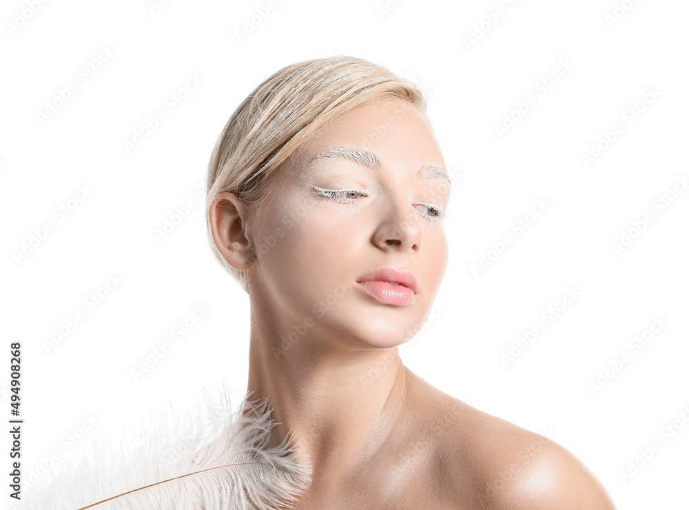 Beautiful young woman with creative makeup and feather on white background