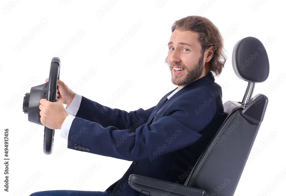 Young businessman in car seat and with steering wheel on white background