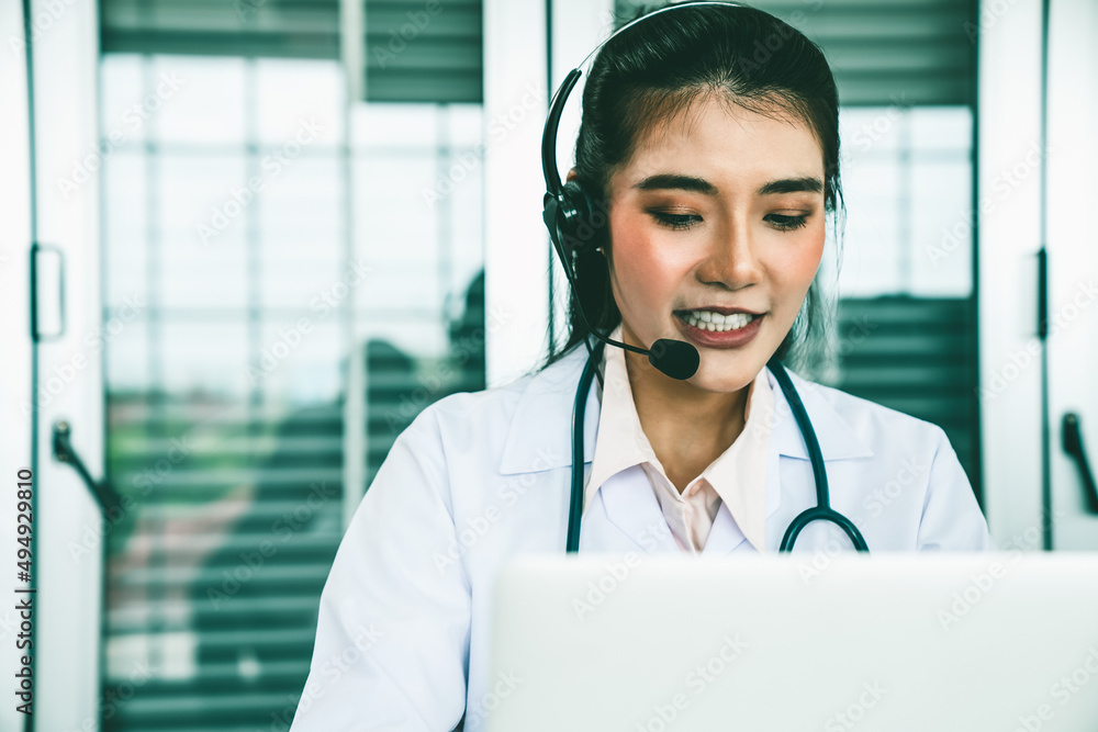 Doctor wearing headset talking actively on video call in hospital or clinic . Concept of telehealth 